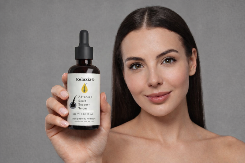 Woman holding Relaxiz Advanced Scalp Support Serum for daily scalp care