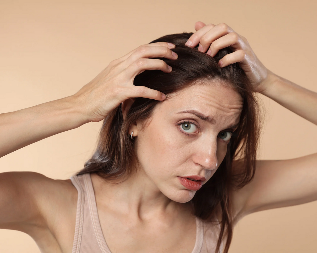 Applying a lightweight scalp serum with a dropper to the scalp as part of a daily scalp care routine